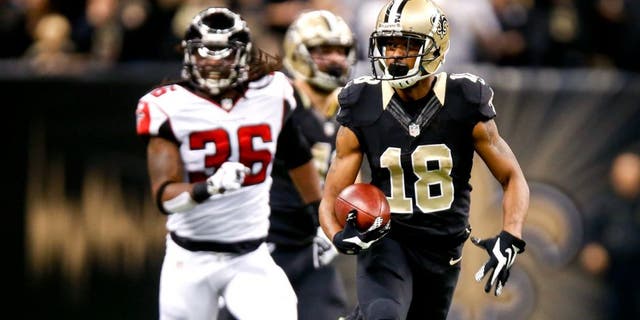 Dec 21, 2014; New Orleans, LA, USA; New Orleans Saints wide receiver Jalen Saunders (18) returns the opening kickoff as Atlanta Falcons strong safety Kemal Ishmael (36) chases during the first quarter at the Mercedes-Benz Superdome. Mandatory Credit: Derick E. Hingle-USA TODAY Sports