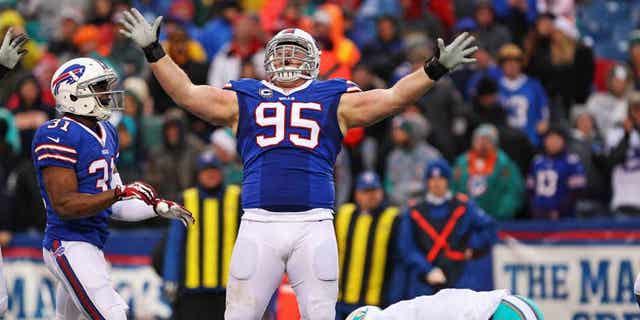 Dec 22, 2013; Orchard Park, NY, USA; Buffalo Bills defensive tackle Kyle Williams (95) celebrates a sack on Miami Dolphins quarterback Ryan Tannehill (17) during the second half at Ralph Wilson Stadium. Buffalo beats Miami 19-0. Mandatory Credit: Timothy T. Ludwig-USA TODAY Sports
