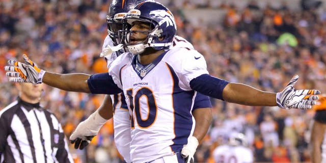 Denver Broncos wide receiver Emmanuel Sanders (10) reacts following a 4-yard touchdown reception during the second half of an NFL football game against the Cincinnati Bengals Monday, Dec. 22, 2014, in Cincinnati. (AP Photo/AJ Mast)