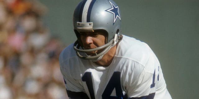 CIRCA 1970: Quarterback Craig Morton #14 of the Dallas Cowboys stands under center Dave Manders #51 during an NFL football game circa 1970. Morton played for the Cowboy from 1965-74. (Photo by Focus on Sport/Getty Images) *** Local Caption *** Craig Morton;Dave Manders