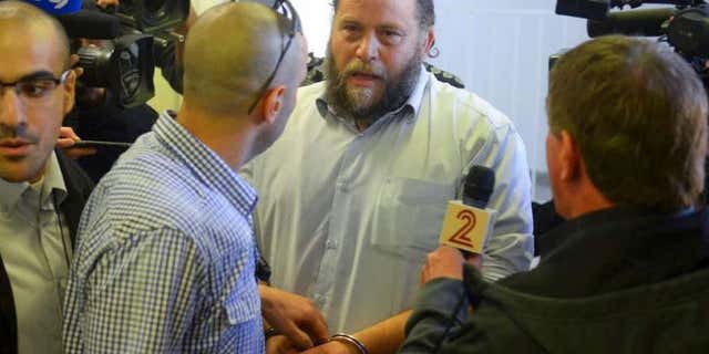 Dec. 16, 2014: Bentzi Gopstein, leader of the extreme right-wing movement Lehava, is handcuffed as he arrives for his hearing at a Jerusalem Court.
