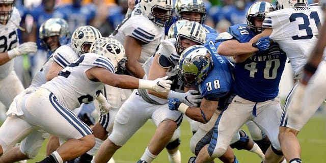 Dec 22, 2014; Miami, FL, USA; Memphis Tigers running back Brandon Hayes (38) is tackled by Brigham Young Cougars defense during the third quarter in the Miami Beach Bowl at Marlins Park. Memphis won 55-48 in a double overtime. Mandatory Credit: Steve Mitchell-USA TODAY Sports