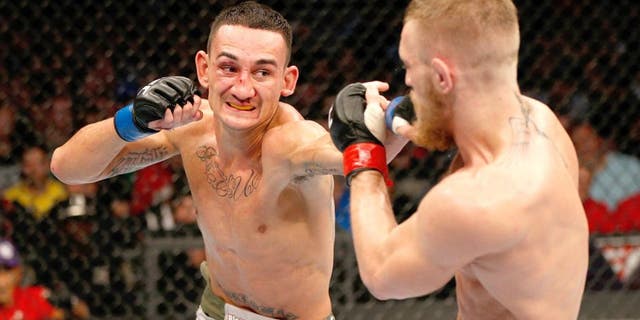 BOSTON, MA - AUGUST 17: (L-R) Max Holloway punches Conor McGregor in their UFC featherweight bout at TD Garden on August 17, 2013 in Boston, Massachusetts. (Photo by Josh Hedges/Zuffa LLC/Zuffa LLC via Getty Images)