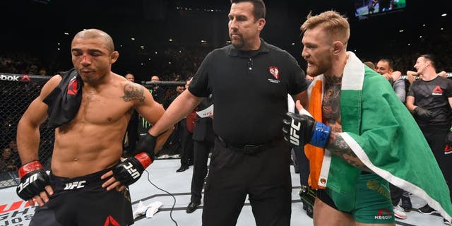 LAS VEGAS, NV - DECEMBER 12: Jose Aldo of Brazil (left) and Conor McGregor of Ireland (right) await the final decision in their UFC featherweight championship bout during the UFC 194 event inside MGM Grand Garden Arena on December 12, 2015 in Las Vegas, Nevada. (Photo by Josh Hedges/Zuffa LLC/Zuffa LLC via Getty Images)