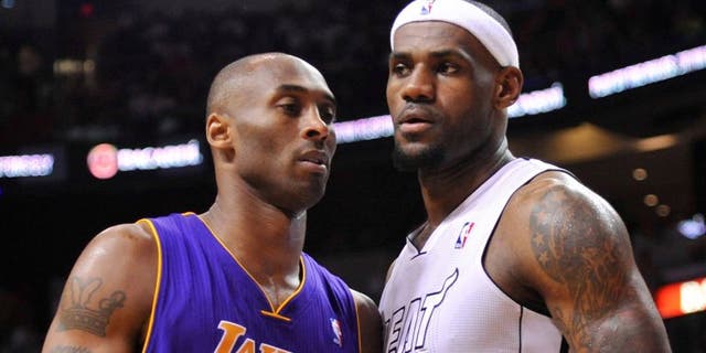 Feb 10, 2013; Miami, FL, USA; Los Angeles Lakers shooting guard Kobe Bryant (24) and Miami Heat small forward LeBron James (6) during the first half at American Airlines Arena. Mandatory Credit: Steve Mitchell-USA TODAY Sports