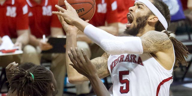 Nebraska forward Terran Petteway (5) drives down the lane with the basketball while defended by Ohio forward Maurice Ndour (5) in the second half of an NCAA college basketball game at the Diamond Head Classic on Thursday, Dec. 25, 2014, in Honolulu. Nebraska defeated Ohio 71-58. (AP Photo/Eugene Tanner)