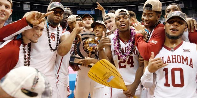 Dec 25, 2015; Honolulu, HI, USA; The Oklahoma Sooners celebrate after defeating the Harvard Crimson at the Stan Sheriff Center. Oklahoma Sooners defeated the Harvard Crimson 83-71. Mandatory Credit: Marco Garcia-USA TODAY Sports