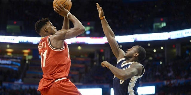 Dec 25, 2015; Oklahoma City, OK, USA; Chicago Bulls guard Jimmy Butler (21) shoots the ball against Oklahoma City Thunder guard Dion Waiters (3) during the second half of a NBA basketball game on Christmas at Chesapeake Energy Arena. Mandatory Credit: Mark D. Smith-USA TODAY Sports