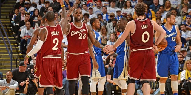 OAKLAND, CA - DECEMBER 25: LeBron James #23 and Kevin Love #0 and Kyrie Irving #2 of the Cleveland Cavaliers shake hands on against the Golden State Warriors on December 25, 2015 at ORACLE Arena in Oakland,California.NOTE TO USER: User expressly acknowledges and agrees that, by downloading and or using this Photograph, user is consenting to the terms and conditions of the Getty Images License Agreement. Mandatory Copyright Notice: Copyright 2015 NBAE (Photo by Noah Graham/NBAE via Getty Images)