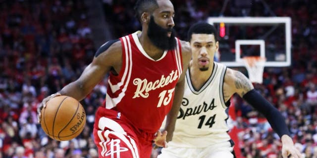 HOUSTON, TX - DECEMBER 25: James Harden #13 of the Houston Rockets drives with the basketball against Danny Green #14 of the San Antonio Spurs during their game at the Toyota Center on December 25, 2015 in Houston, Texas. NOTE TO USER: User expressly acknowledges and agrees that, by downloading and or using this Photograph, user is consenting to the terms and conditions of the Getty Images License Agreement. (Photo by Scott Halleran/Getty Images)