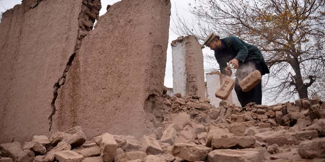 Dec. 26, 2015: An Afghan villager removes bricks after his home was damaged from an earthquake in Surkhroad district of Jalalabad east of Kabul, Afghanistan.