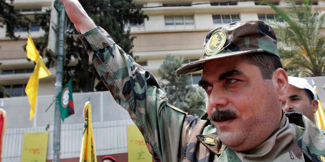 FILE - In this July 17, 2008, file photo, released prisoner Samir Kantar salutes people as he arrives to pay respect at the grave of slain top Hezbollah military commander Imad Mughniyeh, south of Beirut, Lebanon.