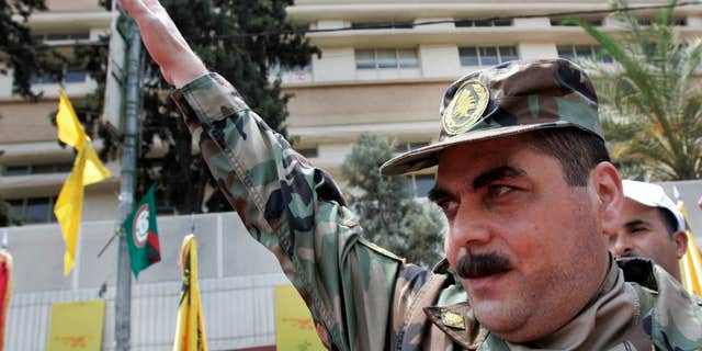 FILE - In this July 17, 2008, file photo, released prisoner Samir Kantar salutes people as he arrives to pay respect at the grave of slain top Hezbollah military commander Imad Mughniyeh, south of Beirut, Lebanon.