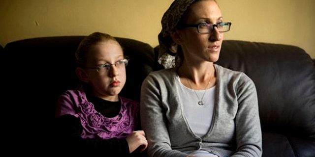 December 26, 2011: Naama Margolese, 8, sits with her mother Hadassa in their home in the central Israeli town of Beit Shemesh.