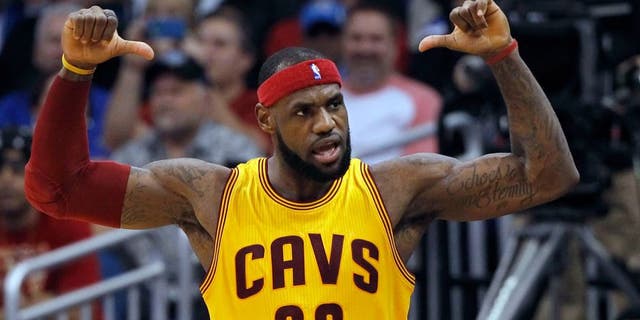 Dec 26, 2014; Orlando, FL, USA; Cleveland Cavaliers forward LeBron James (23) points to his back of his jersey after he made a shot during the fourth quarter against the Orlando Magic at Amway Center. Cleveland Cavaliers defeated the Orlando Magic 98-89. Mandatory Credit: Kim Klement-USA TODAY Sports