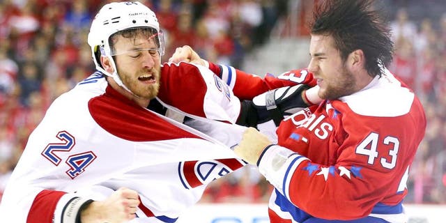 WASHINGTON, DC - DECEMBER 26: Jarred Tinordi #24 of the Montreal Canadiens and Tom Wilson #43 of the Washington Capitals exchange punches during the first period at Verizon Center on December 26, 2015 in Washington, DC. (Photo by Maddie Meyer/Getty Images)
