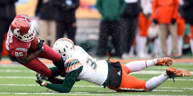 Dec 26, 2015; El Paso, TX, USA; Miami Hurricanes defensive lineman Trent Harris (33) tackles Washington State Cougars wide receiver John Thompson (85) during the second half at Sun Bowl Stadium. Mandatory Credit: Joe Camporeale-USA TODAY Sports