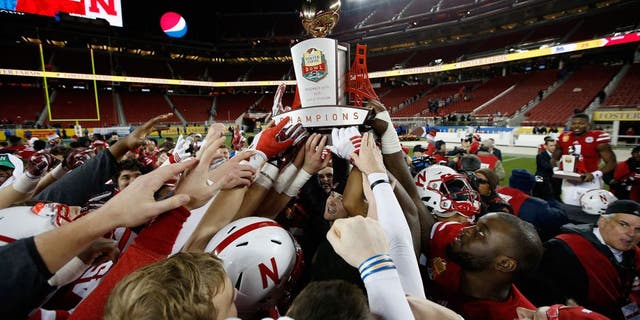 SANTA CLARA, CA - DECEMBER 26: The Nebraska Cornhuskers celebrate with the trophy after they beat the UCLA Bruins in the Foster Farms Bowl at Levi's Stadium on December 26, 2015 in Santa Clara, California. (Photo by Ezra Shaw/Getty Images)