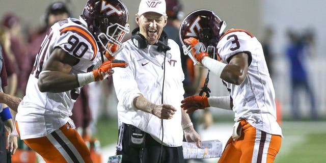 Dec 26, 2015; Shreveport, LA, USA; Virginia Tech Hokies head coach Frank Beamer celebrates with defensive end Dadi Lhomme Nicolas (90) and cornerback Greg Stroman (3) after Stroman returns a punt for a touchdown during the second quarter against the Tulsa Golden Hurricane at Independence Stadium. Mandatory Credit: Troy Taormina-USA TODAY Sports