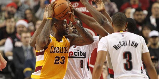 Dec 26, 2015; Portland, OR, USA; Portland Trail Blazers forward Al-Farouq Aminu (8) defends Cleveland Cavaliers forward LeBron James (23) at Moda Center at the Rose Quarter. Mandatory Credit: Jaime Valdez-USA TODAY Sports