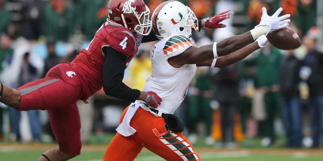 Miami receiver Herb Waters stretches to reach a long pass in front of Washington State defender Charleston White during the first half of the Sun Bowl NCAA college football game Saturday Dec. 26, 2015 in El Paso, Texas. (AP Photo/Victor Calzada)