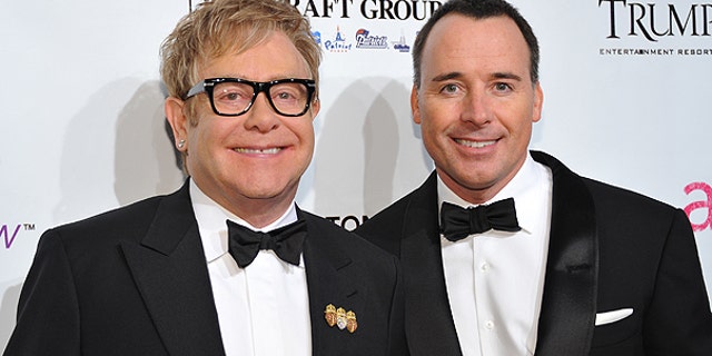 In this Oct. 18, 2010 file photo, Sir Elton John, left, and husband David Furnish attend the Ninth Annual Elton John AIDS Foundation benefit 'An Enduring Vision' at Cipriani Wall Street in New York.