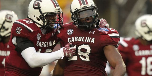 Dec 27, 2014; Shreveport, LA, USA; South Carolina Gamecocks linebacker Skai Moore (10) and linebacker Jonathan Walton (28) celebrate after an interception by Walton in the second quarter against the Miami Hurricanes in the 2014 Independence Bowl at Independence Stadium. Mandatory Credit: Nelson Chenault-USA TODAY Sports