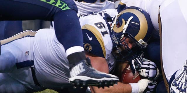Dec 27, 2015; Seattle, WA, USA; St. Louis Rams center Tim Barnes (61) recovers a fumble against the Seattle Seahawks during the fourth quarter at CenturyLink Field. Mandatory Credit: Joe Nicholson-USA TODAY Sports