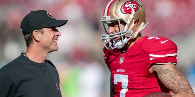 Dec 28, 2014; Santa Clara, CA, USA; San Francisco 49ers head coach Jim Harbaugh talks with quarterback Colin Kaepernick (7) during warmups before the game against the Arizona Cardinals at Levi's Stadium. The against the San Francisco 49ers defeated the Arizona Cardinals 20-17. Mandatory Credit: Ed Szczepanski-USA TODAY Sports