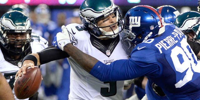 Dec 28, 2014; East Rutherford, NJ, USA; New York Giants defensive end Jason Pierre-Paul (90) sacks Philadelphia Eagles quarterback Mark Sanchez (3) in the second half during the game at MetLife Stadium. Mandatory Credit: Robert Deutsch-USA TODAY Sports