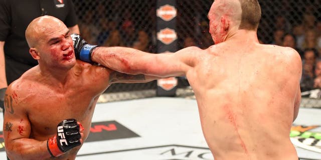 LAS VEGAS, NV - JULY 11: (R-L) Rory MacDonald punches Robbie Lawler in their UFC welterweight title fight during the UFC 189 event inside MGM Grand Garden Arena on July 11, 2015 in Las Vegas, Nevada. (Photo by Josh Hedges/Zuffa LLC/Zuffa LLC via Getty Images)