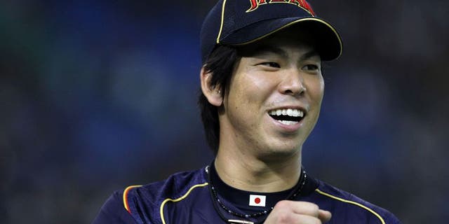 TOKYO, JAPAN - MARCH 10: Pitcher Kenta Maeda #20 of Japan celebrates after in the bottom half of the second inning during the World Baseball Classic Second Round Pool 1 game between Japan and the Netherlands at Tokyo Dome on March 10, 2013 in Tokyo, Japan. (Photo by Koji Watanabe/Getty Images)