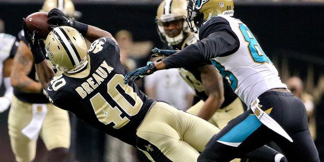 Dec 27, 2015; New Orleans, LA, USA; New Orleans Saints cornerback Delvin Breaux (40) intercepts a pass in front of Jacksonville Jaguars wide receiver Allen Hurns (88) during the second quarter of a game at the Mercedes-Benz Superdome. Mandatory Credit: Derick E. Hingle-USA TODAY Sports