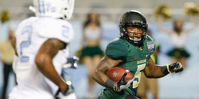 Dec 29, 2015; Orlando, FL, USA; Baylor Bears running back Johnny Jefferson (5) looks back at North Carolina Tar Heels cornerback Des Lawrence (2) before scoring on a touchdown run during the second quarter of a football game at Florida Citrus Bowl. Mandatory Credit: Reinhold Matay-USA TODAY Sports