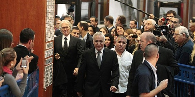 Dec. 30: Israel's former president Moshe Katsav (C) arrives at Tel Aviv District Court to hear the verdict on charges of rape and sexual misconduct against him.