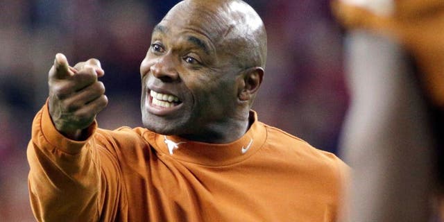 Texas head coach Charlie Strong yells to his players during the first half of the Texas Bowl NCAA college football game against Arkansas Monday, Dec. 29, 2014, in Houston. (AP Photo/David J. Phillip)