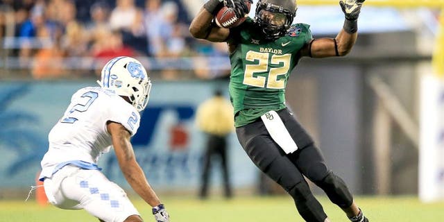 ORLANDO, FL - DECEMBER 29: Terence Williams #22 of the Baylor Bears is defended by Des Lawrence #2 of the North Carolina Tar Heels of the Russell Athletic Bowl game at Orlando Citrus Bowl on December 29, 2015 in Orlando, Florida. (Photo by Rob Foldy/Getty Images)