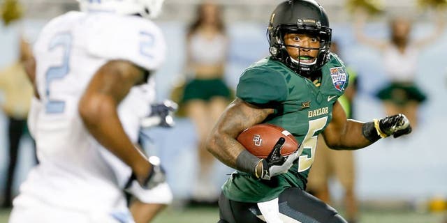 Dec 29, 2015; Orlando, FL, USA; Baylor Bears running back Johnny Jefferson (5) looks back at North Carolina Tar Heels cornerback Des Lawrence (2) before scoring on a touchdown run during the second quarter of a football game at Florida Citrus Bowl. Mandatory Credit: Reinhold Matay-USA TODAY Sports