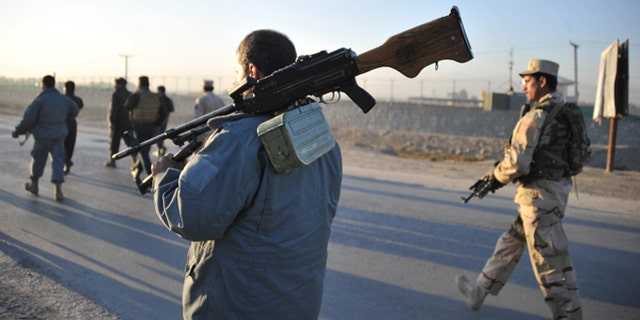 Dec. 2, 2012: Afghan security forces patrol the site where Taliban suicide bombers attacked a joint U.S.-Afghan air base in Jalalabad, east of Kabul, Afghanistan.