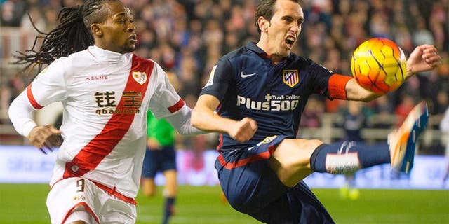 Rayo Vallecano's Angolan forward Alberto Manucho (L) vies with Atletico Madrid's Uruguayan defender Diego Godin during the Spanish league football match Rayo Vallecano de Madrid vs Club Atletico de Madrid at Vallecas stadium in Madrid on December 30, 2015. AFP PHOTO/ CURTO DE LA TORRE / AFP / CURTO DE LA TORRE (Photo credit should read CURTO DE LA TORRE/AFP/Getty Images)