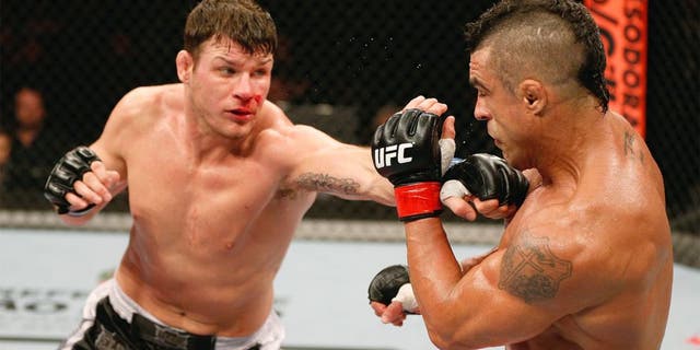 SAO PAULO, BRAZIL - JANUARY 19: (L-R) Michael Bisping punches Vitor Belfort in their middleweight fight at the UFC on FX event on January 19, 2013 at Ibirapuera Gymnasium in Sao Paulo, Brazil. (Photo by Josh Hedges/Zuffa LLC/Zuffa LLC via Getty Images)