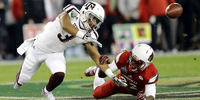 Louisville safety Chucky Williams, right, breaks up a pass intended for Texas A&M wide receiver Christian Kirk (3) in the first half of the Music City Bowl NCAA college football game Wednesday, Dec. 30, 2015, in Nashville, Tenn. (AP Photo/Mark Humphrey)
