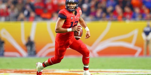 Dec 31, 2014; Glendale, AZ, USA; Arizona Wildcats quarterback Anu Solomon (12) scrambles in the second quarter against the Boise State Broncos in the 2014 Fiesta Bowl at Phoenix Stadium. Mandatory Credit: Mark J. Rebilas-USA TODAY Sports