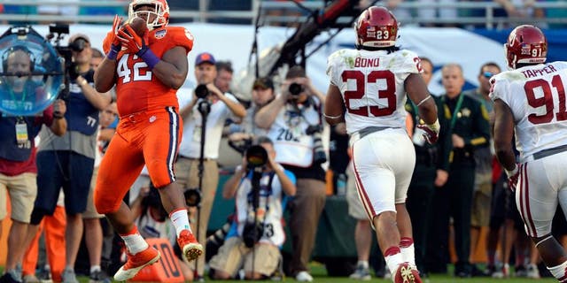 Dec 31, 2015; Miami Gardens, FL, USA; Clemson Tigers defensive lineman Christian Wilkins (42) catches a pass on a fake punt against the Oklahoma Sooners during the first half of the 2015 CFP semifinal at the Orange Bowl at Sun Life Stadium. Mandatory Credit: Tommy Gilligan-USA TODAY Sports