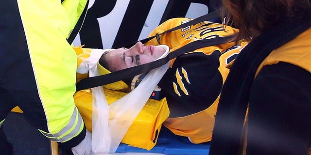 FOXBORO, MA - DECEMBER 31: Denna Laing #24 of the Boston Pride (NWHL) is taken off the ice following an injury against the Les Canadiennes (CWHL) during the Outdoor Womens Classic at Gillette Stadium on December 31, 2015 in Foxboro, Massachusetts. (Photo by Maddie Meyer/Getty Images)