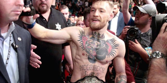 LAS VEGAS, NV - DECEMBER 12: Conor McGregor leaves the Octagon after his first-round knockout victory over Jose Aldo in their featherweight title fight during UFC 194 on December 12, 2015 in Las Vegas, Nevada. (Photo by Steve Marcus/Getty Images)