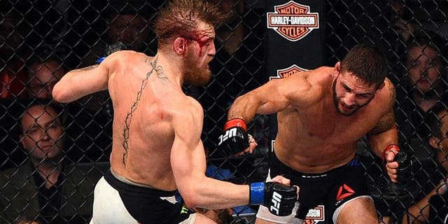 LAS VEGAS, NV - JULY 11: (L-R) Conor McGregor punches Chad Mendes during the UFC 189 event inside MGM Grand Garden Arena on July 11, 2015 in Las Vegas, Nevada. (Photo by Jeff Bottari/Zuffa LLC/Zuffa LLC via Getty Images)