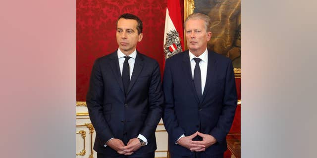 New Austrian Chancellor Christian Kern and Vice Chancellor Reinhold Mitterlehner, from left, attend an inauguration ceremony of four new ministers at the Hofburg palace in Vienna, Austria, Wednesday, May 18, 2016. (AP Photo/Ronald Zak)
