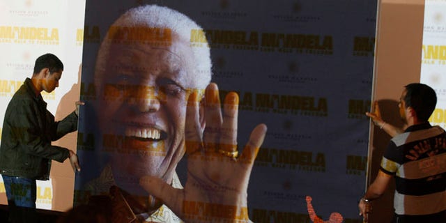 Nov. 2, 2013: In this file photo, a giant poster of Nelson Mandela is moved to center stage at a news conference held to promote the newly released film "Mandela: Long Walk To Freedom," in Johannesburg.