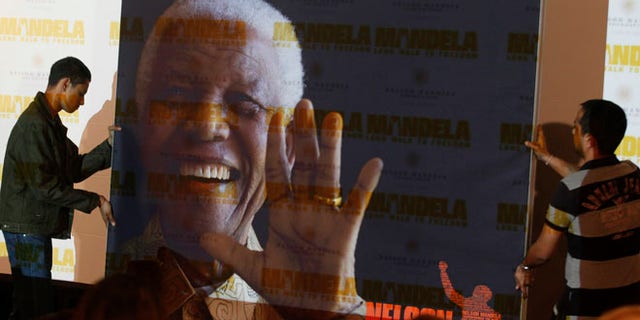 Nov. 2, 2013: In this file photo, a giant poster of Nelson Mandela is moved to center stage at a news conference held to promote the newly released film "Mandela: Long Walk To Freedom," in Johannesburg.